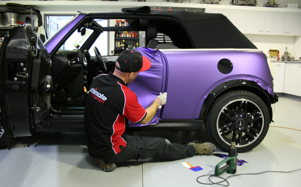 Wrapping door jambs on Mini Cooper S with Avery matte metallic purple vinyl Ultimate Car Wraps